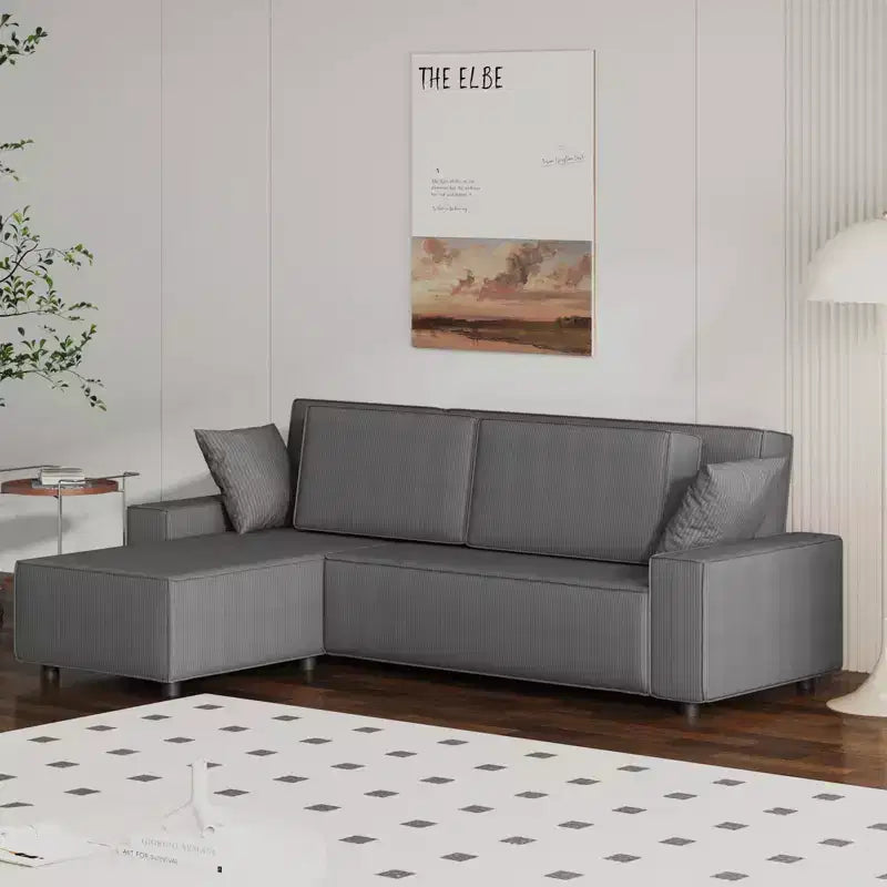 Divano sezionale a L in velluto a coste con pouf mobile